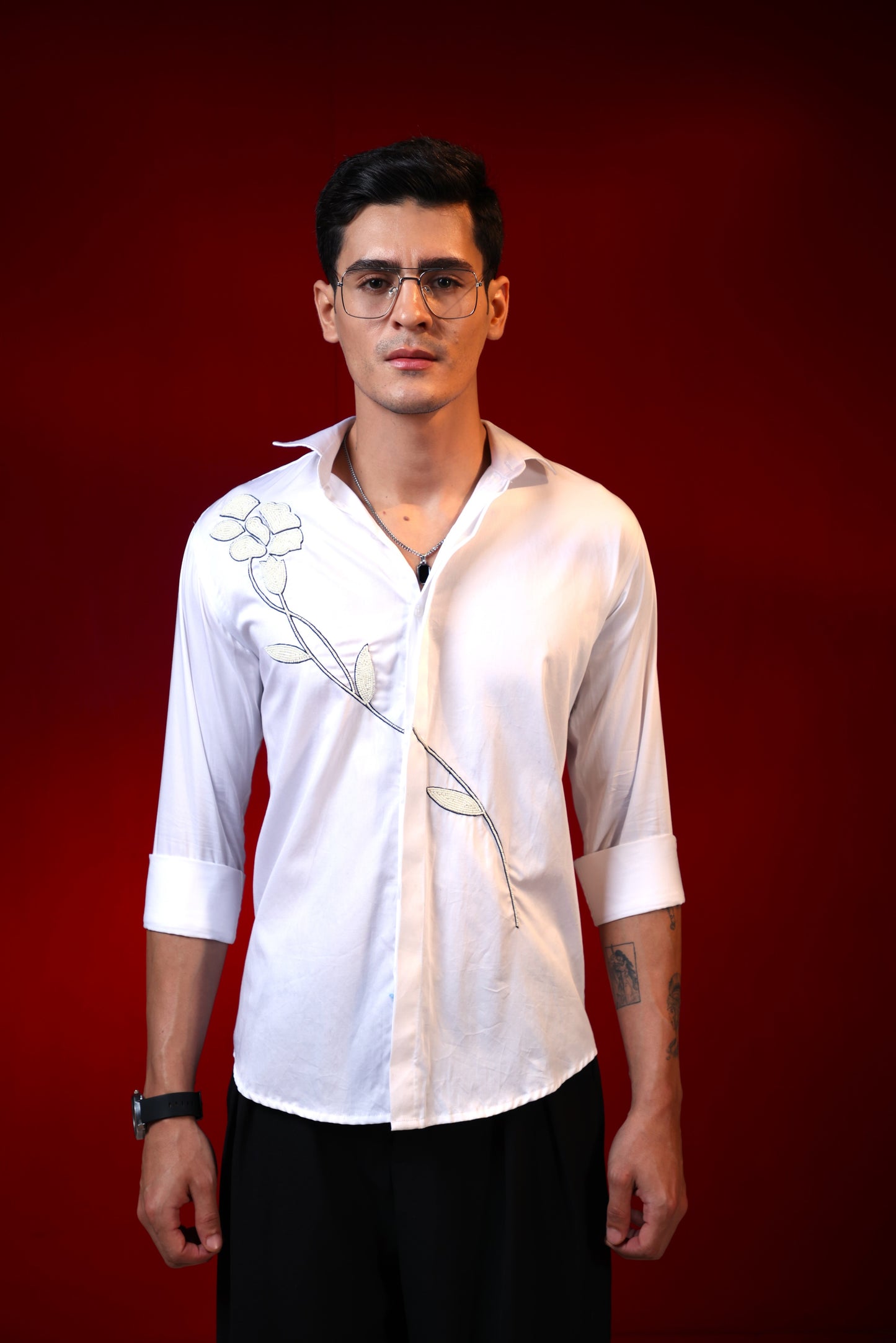 FLOWER MADE OF PEARLS EMBROIDERED ON A WHITE SHIRT