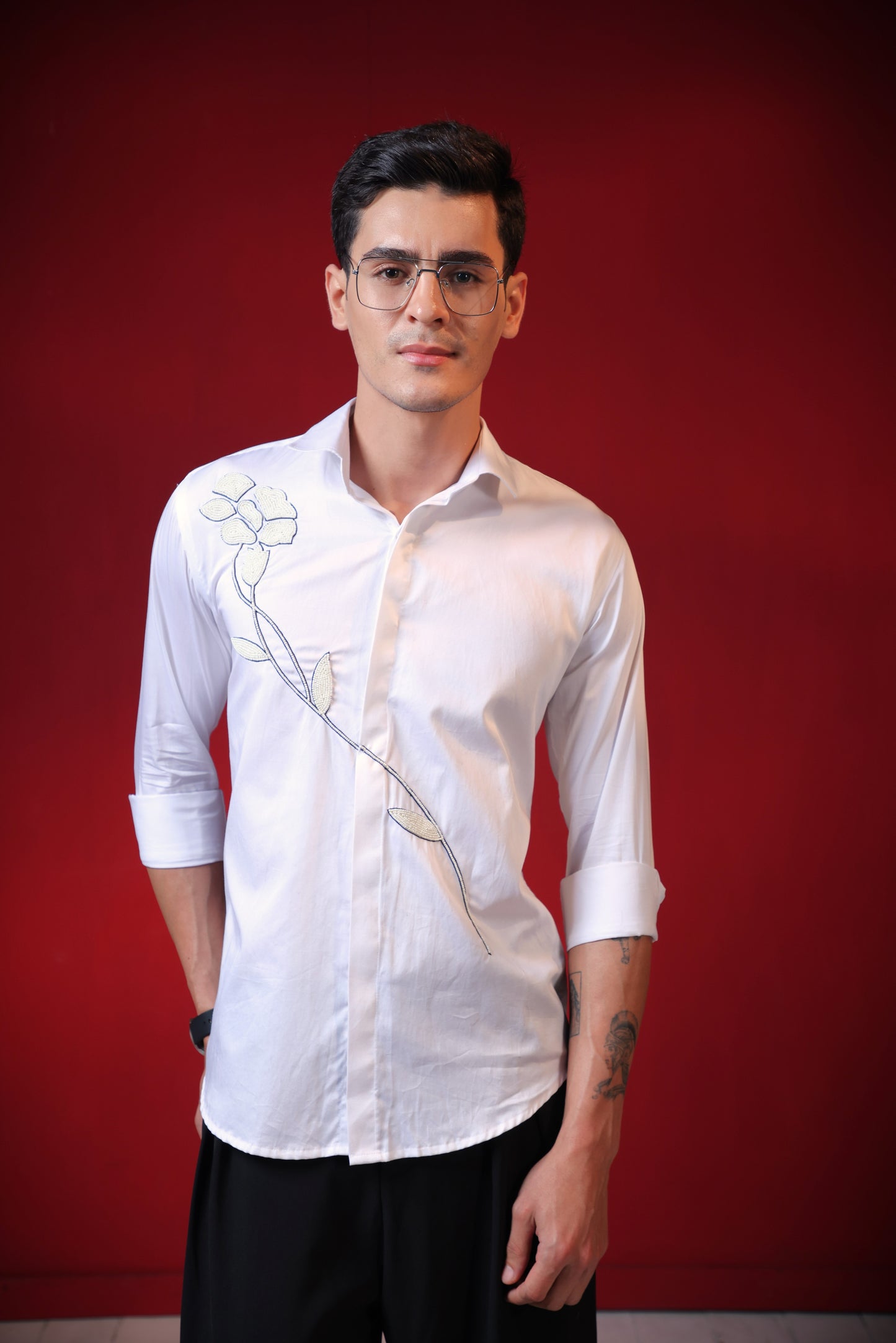 FLOWER MADE OF PEARLS EMBROIDERED ON A WHITE SHIRT