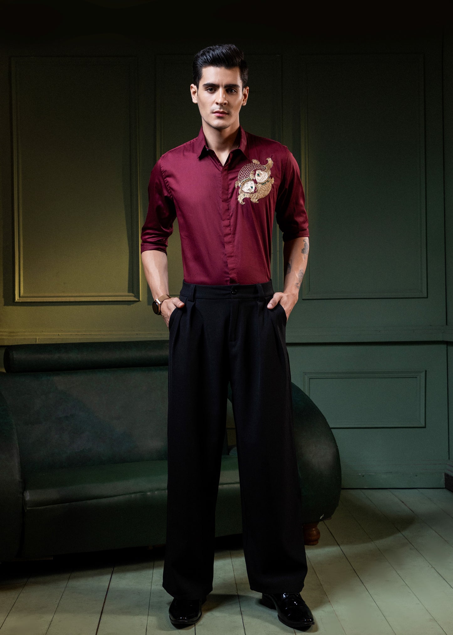 TWO FISH EMBROIDERED ON A MAROON SHIRT