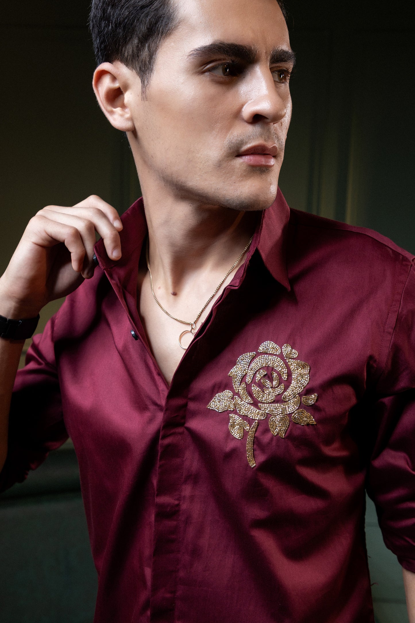 GOLDEN FLOWER EMBROIDERED ON A MAROON SHIRT
