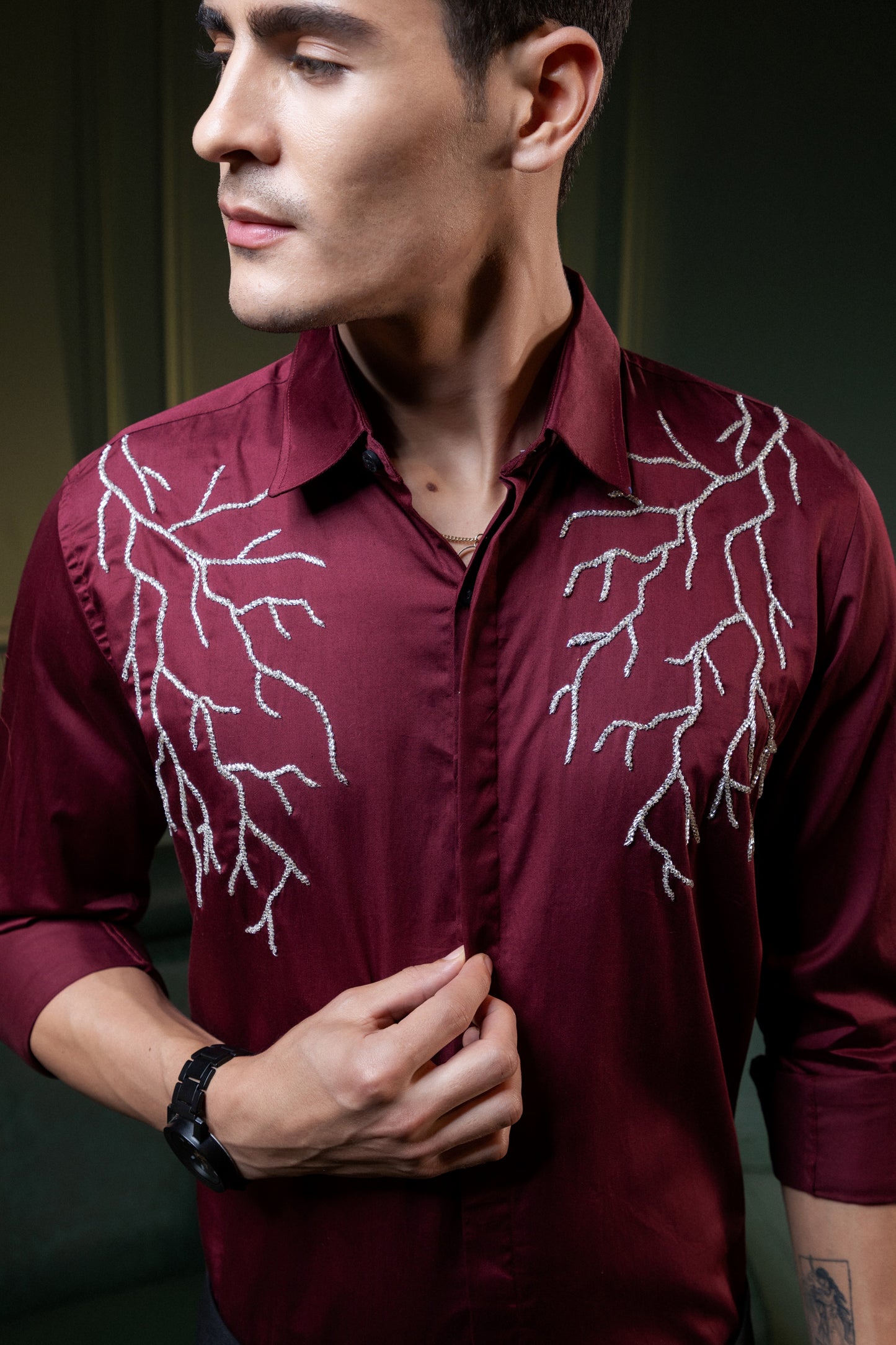 SILVER LIGHT EMBROIDERED ON A MAROON SHIRT