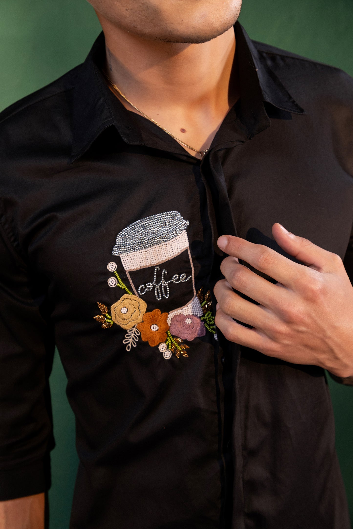 A MUG OF COFFEE EMBROIDERED ON A SHIRT