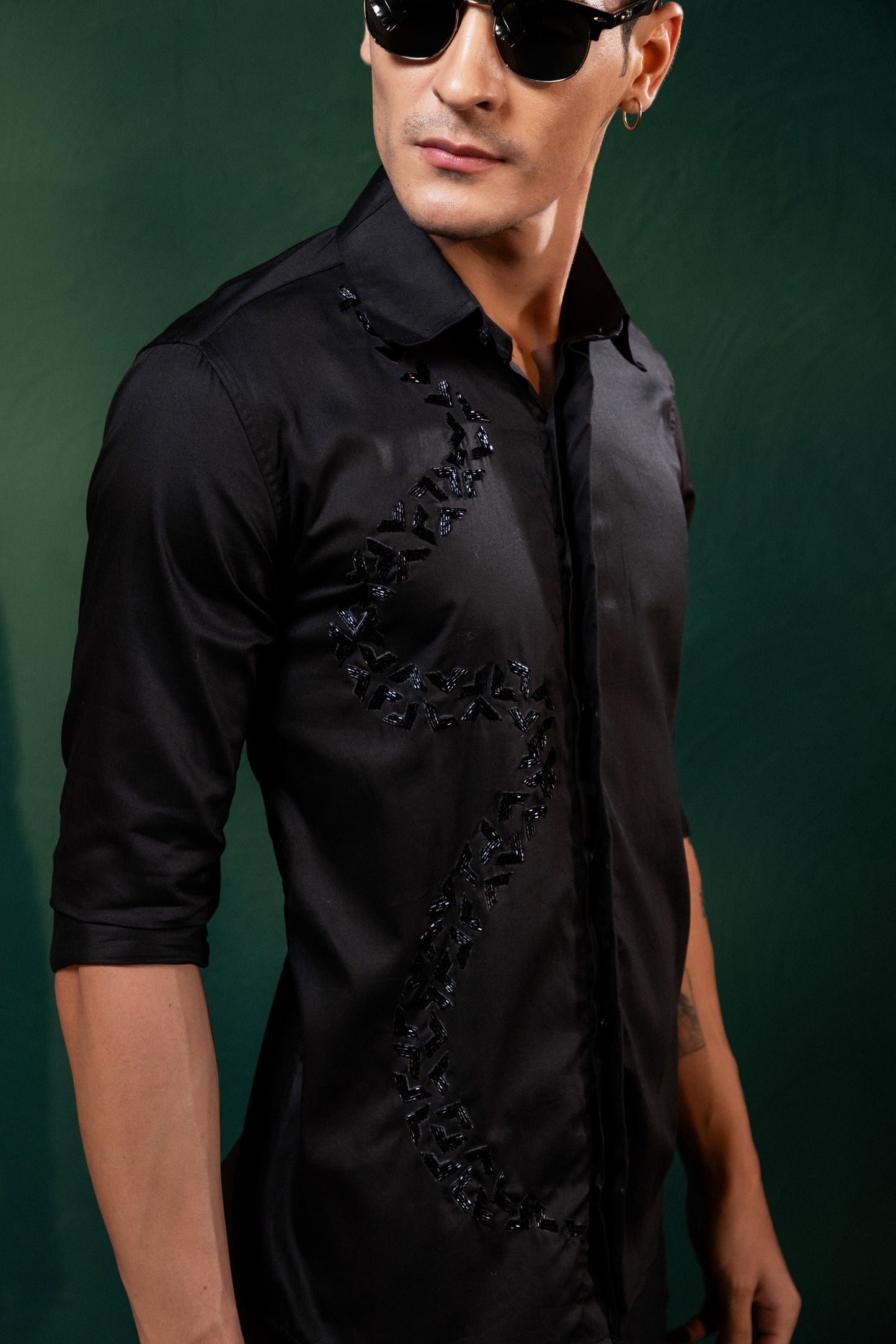 A SPIRAL SHAPED EMBROIDERY ON A BLACK SHIRT