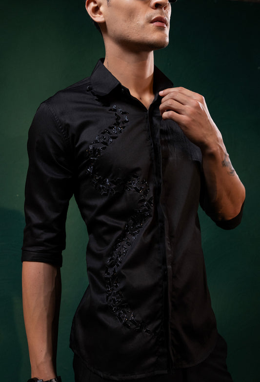 A SPIRAL SHAPED EMBROIDERY ON A BLACK SHIRT