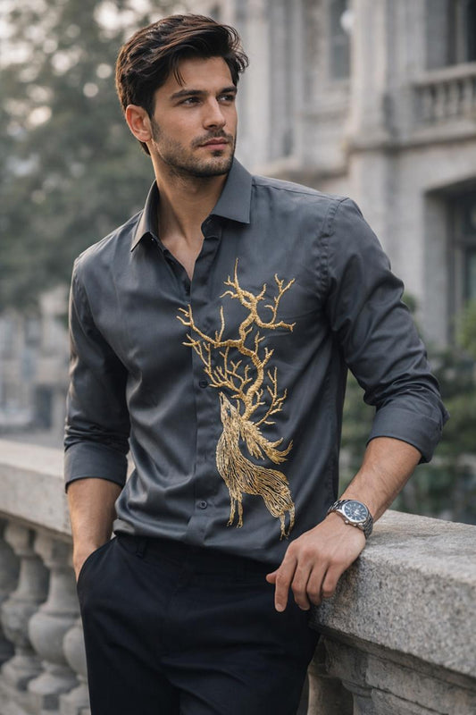 A REINDEER HAND EMBROIDERED ON A BLACK SHIRT