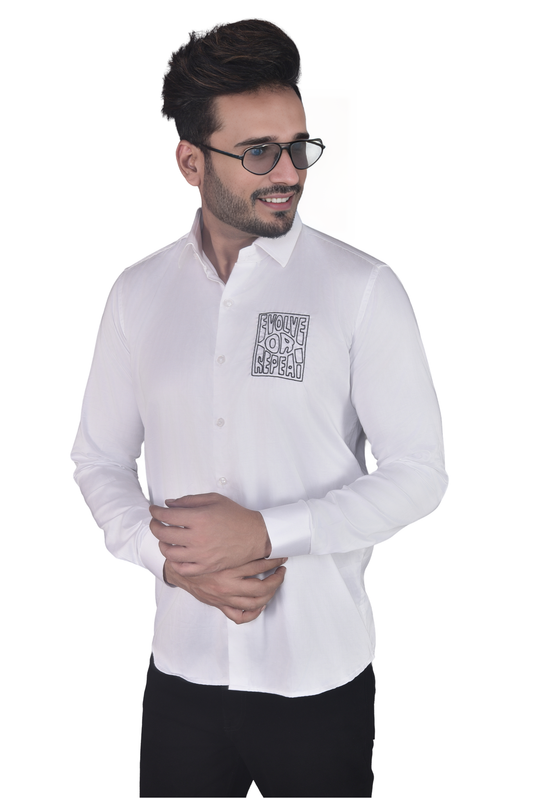 'EVOLVE OR REPEAT' HAND EMBROIDERED ON A WHITE SHIRT