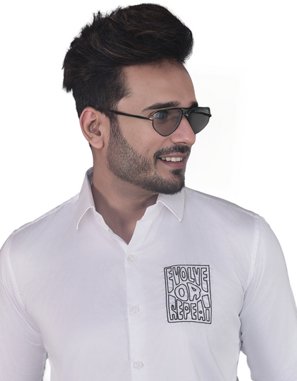 'EVOLVE OR REPEAT' HAND EMBROIDERED ON A WHITE SHIRT