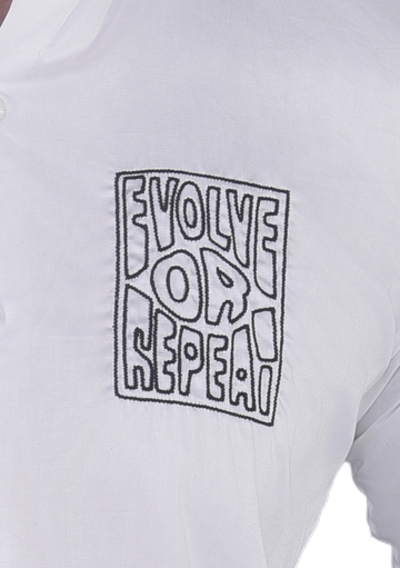 'EVOLVE OR REPEAT' HAND EMBROIDERED ON A WHITE SHIRT