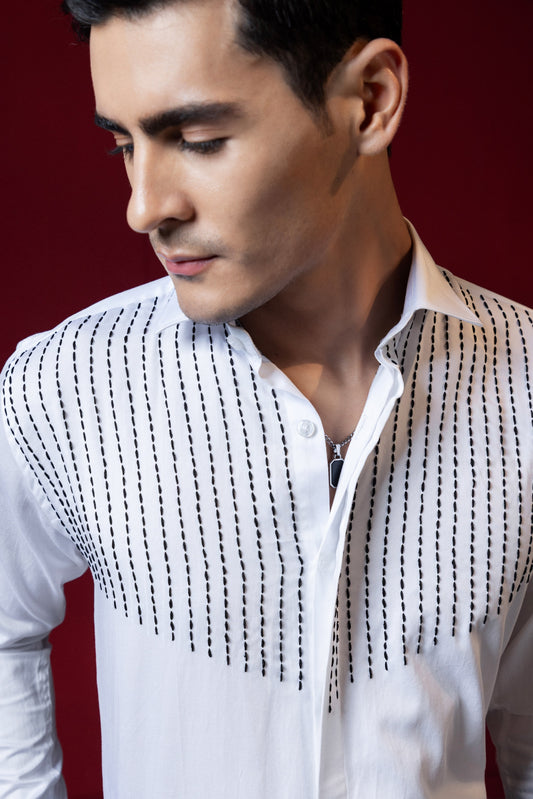 LINES OF THREAD EMBROIDERED ON A WHITE SHIRT