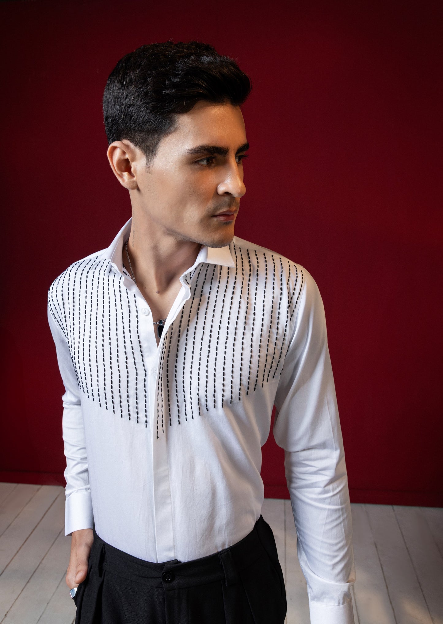 LINES OF THREAD EMBROIDERED ON A WHITE SHIRT