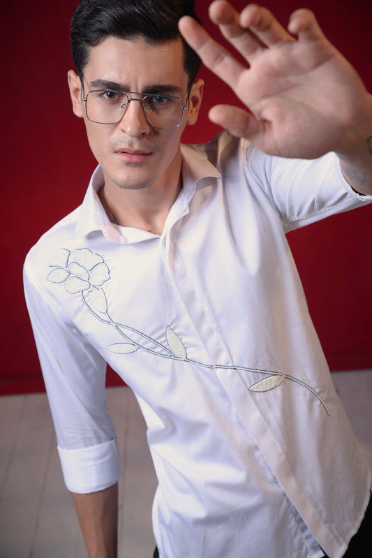 FLOWER MADE OF PEARLS EMBROIDERED ON A WHITE SHIRT