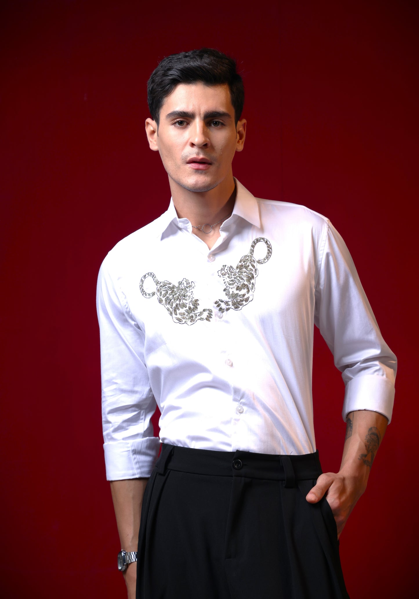 TWO TIGERS EMBROIDERED ON A WHITE SHIRT