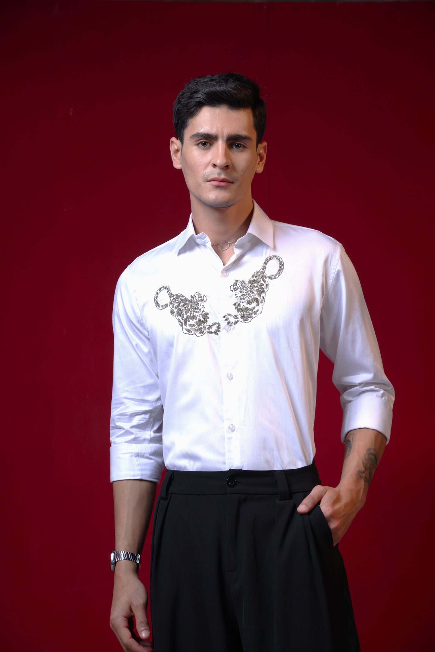 TWO TIGERS EMBROIDERED ON A WHITE SHIRT