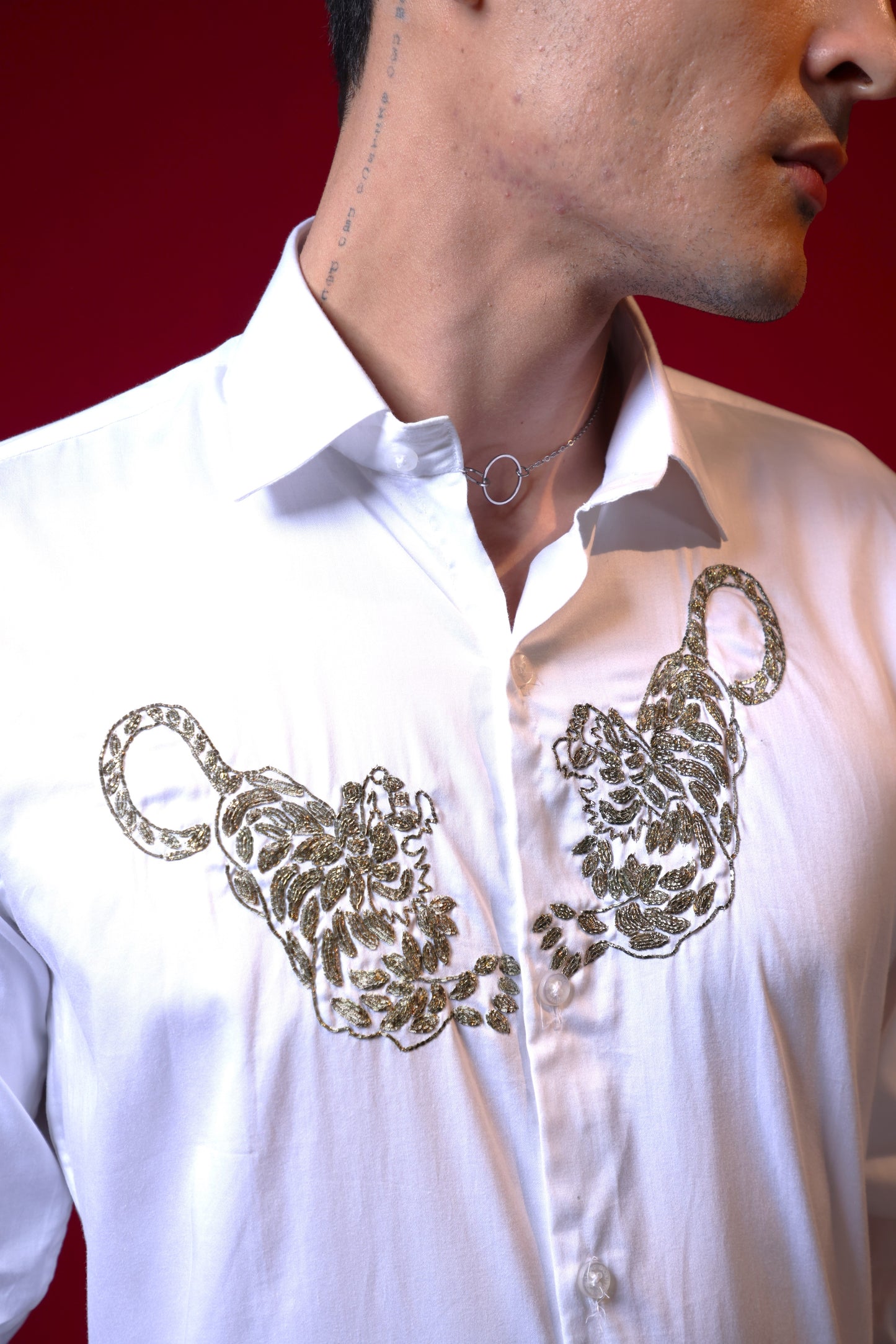 TWO TIGERS EMBROIDERED ON A WHITE SHIRT