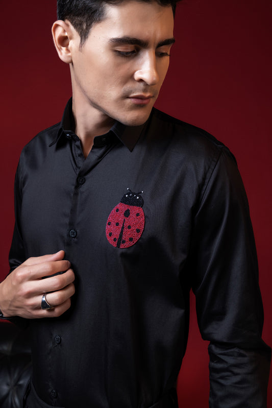 RED BUG HAND EMBROIDERED ON A SHIRT