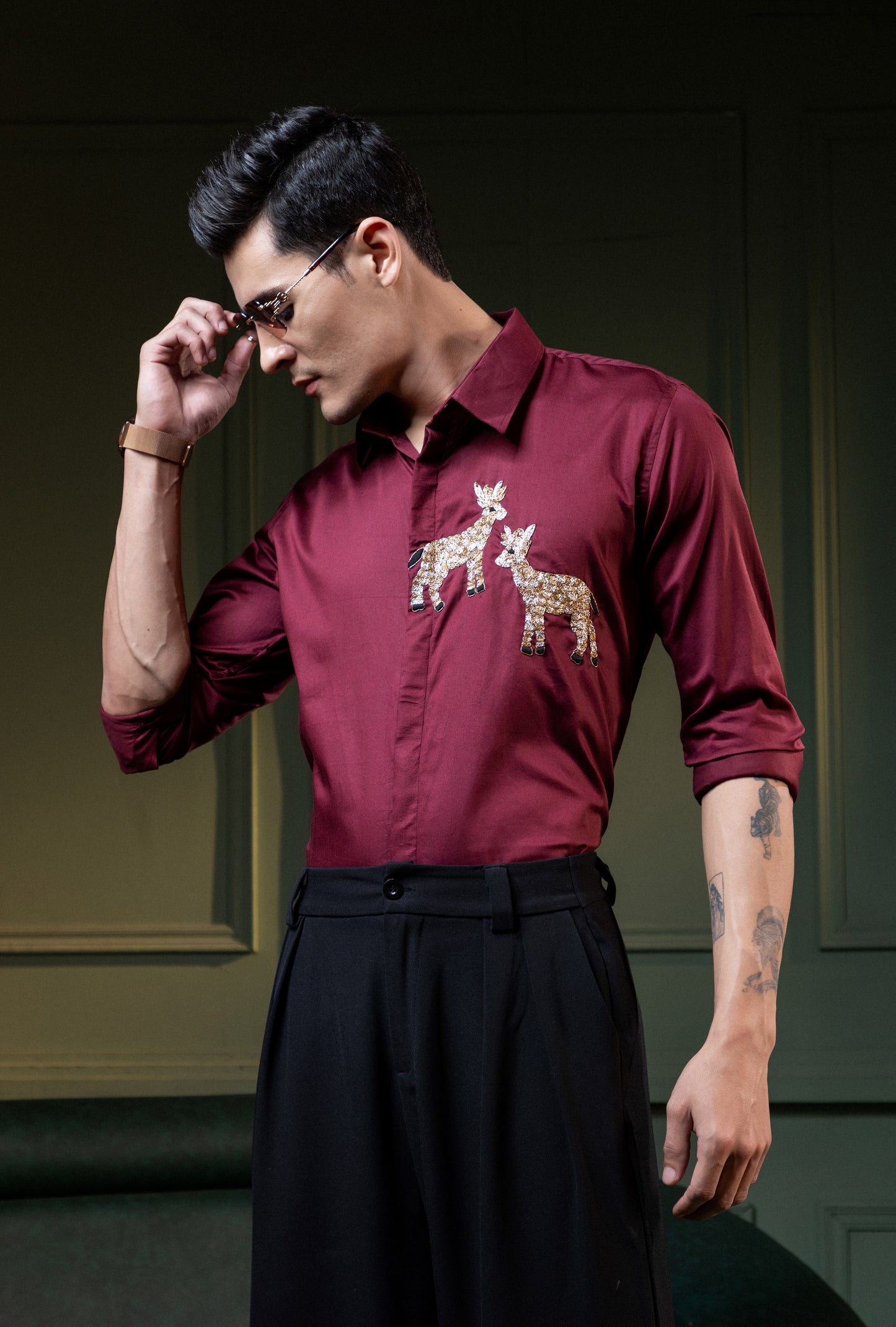 TWO DEER EMBROIDERED ON A MAROON SHIRT