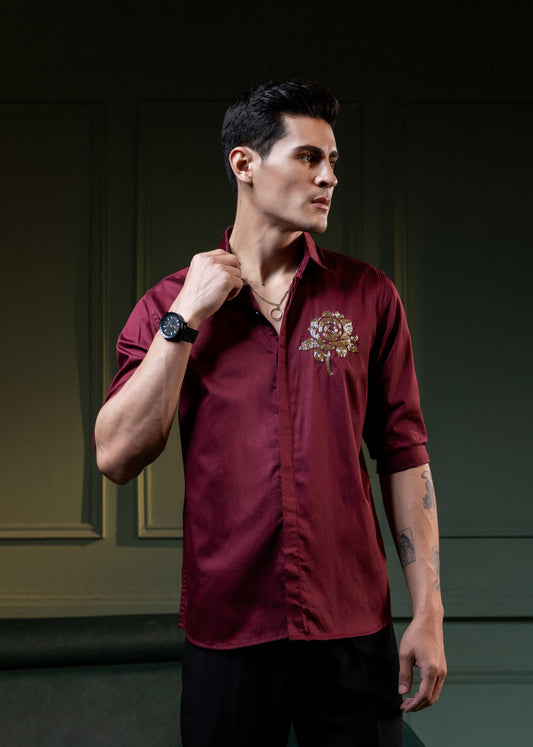 GOLDEN FLOWER EMBROIDERED ON A MAROON SHIRT