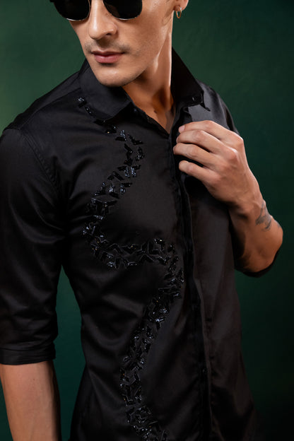 A SPIRAL SHAPED EMBROIDERY ON A BLACK SHIRT